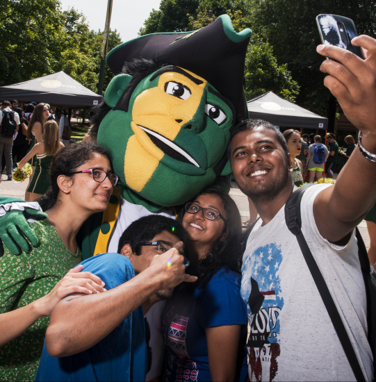 Students taking selfie with Mason patriot