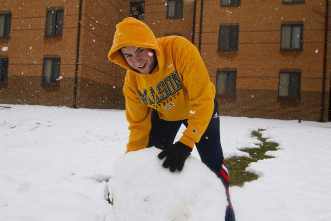 Students make snowman on the Fairfax campus.